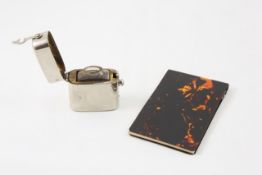 A faux tortoiseshell covered notebook 20th century, together with a travelling inkwell, the small