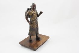 A Japanese Meiji period bronze figure early 20th century, modelled standing, decorated in gilt, on