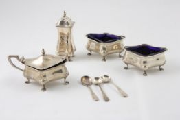 A four piece silver cruet set hallmarked Birmingham 1907/08, of shaped form, with three spoons,