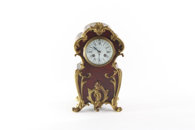 An ormolu mounted mantel clock late 19th century, with simulated tortoiseshell veneer, the enamel