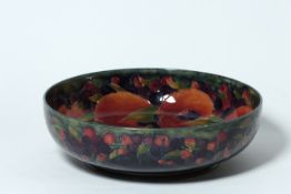 A Moorcroft pottery `Pomegranate` large circular bowl circa 1920, decorated on the interior and