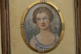 An oval portrait on ivory of a lady in a gilt metal frame decorated with seed pearls circa 1920,