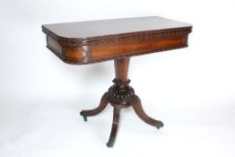A William IV rosewood fold over card table circa 1830, with swivel top revealing a small selection