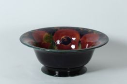 A Moorcroft pottery `Pomegranate` circular bowl circa 1920, decorated on blue ground, with painted