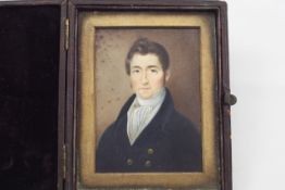 A square portrait miniature on ivory of a gentleman early 19th century, in a fitted leather case,