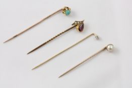Four Victorian stick pins late 19th century, comprising a tear shaped almandine garnet and seed