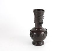 A bronze Chinese vase early 20th century, the tapered neck with figure of a dragon, and birds and