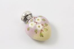 A small Victorian silver topped scent bottle the heart shaped porcelain body decorated with