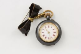 A ladies gold and black burnished pocket watch circa 1900, with white enamel dial and Roman