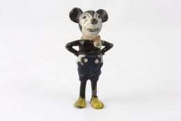 A painted lead figure of Mickey Mouse 1930s, the standing figure with hands on hips, moulded blue