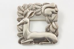 A Georg Jensen deer and squirrel brooch import marks for 1964, pattern number 318 of square form