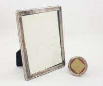 A modern silver photo frame of rectangular form, with beaded border, together with a smaller frame