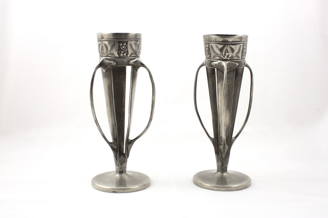 A pair of pewter three handled spill vases Archibald Knox for Liberty & Co circa 1905, with raised