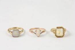 Three 9ct gold rings comprising a ring set with faceted citrine in square setting, an opal ring in