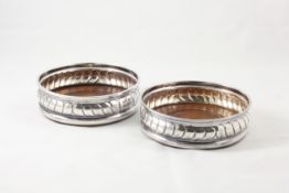 A pair of silver wine coasters hallmarked London 1965/66, diameter 13cm In good overall condition