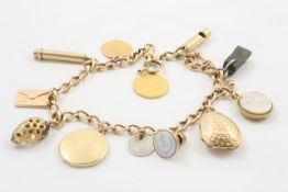 A 9ct gold charm bracelet set with various charms including a seal in the form of a whistle, a