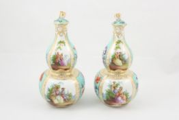 A pair of late 19th century German porcelain vases and stoppers each of double gourd form painted