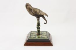 A cold painted bronze budgerigar desk ornament Continental, early 20th century, perched upon a