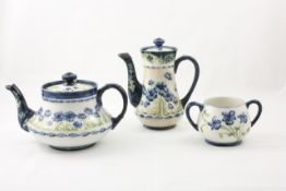 A Moorcroft and Macintyre `Poppy` three piece tea set circa 1903-04, comprising a teapot, water jug,