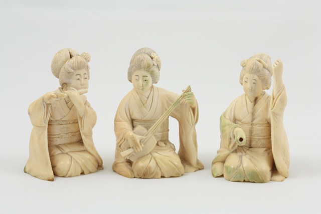 Three 19th century Japanese carved ivory Okimono figures each modelled as kneeling female musicians,