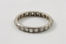 A white metal claw set diamond full eternity ring probably 1920s, with approx 21 diamonds with