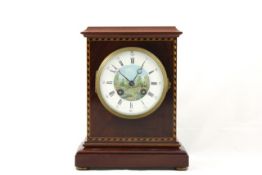 A mahogany French mantel clock circa 1910, with decorated enamel dial and gong striking pendulum