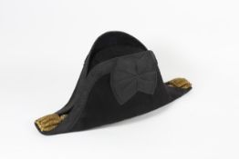 A felt Bicorn hat contained within a fitted tin case with gilt lettering reading F. Cartwright R.