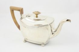 A silver bachelors teapot hallmarked London 1894/95, of squat form with reeded borders, wooden