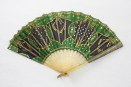 An 19th century fan with horn sticks with applied floral decoration, the green material with black