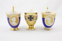 Three porcelain KPM tea cups German, first quarter 20th century, two similar cups with gilt