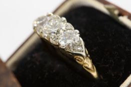An 18ct gold and silver set three stone diamond ring probably 1920s, the centre stone approx ¾ carat