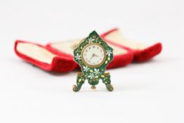 A miniature enamel travelling clock French, circa 1920, by Brevet, in the form of a mantle clock