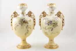 A pair of Minton two handled vases late 19th century, decorated on the front and back with flowers