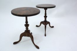 A small pair of George V circular walnut occasional tables raised on turned central column, and