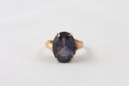 A 14ct gold ring set with synthetic alexandrite Continental, setting supported by two snakes Ring