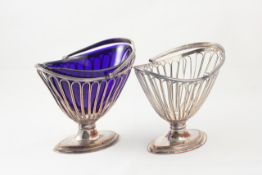 A pair of late 18th century Sheffield silver plate sugar baskets each of oval form with reeded swing