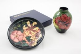 A small pink Moorcroft `Hibiscus` posy vase 1970s, the purple hibiscus flower design on blue/green