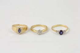 Three 18ct gold engagement rings comprising a ring set with centre sapphire and four small