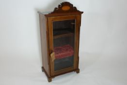 A small mahogany Edwardian table top display cabinet with three display shelves, and shaped and