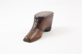 A 19th century mahogany shoe snuff modelled as a gentleman`s shoe with studded detail to the front