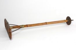 An early 20th century walking stick/seat the lacquered bamboo stick with folding cane seat, length