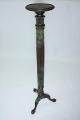 A late Victorian mahogany torchere a circular top above a classical revival column, tripod base with