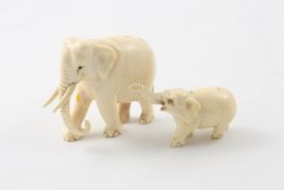 Two carved ivory Indian elephants early 20th century, including mother with tusks and baby, width of