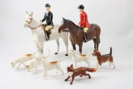 A Beswick hunting group including `Huntsman` on brown horse model number 1501, `Huntswoman` on