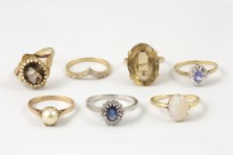 Seven 9ct gold dress rings comprising a ring set with oval opal in claw setting, a ring set with