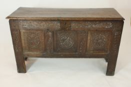 An 18th century oak coffer of rectangular form with later carved front panel, width 108cm, height