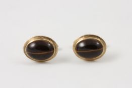 A pair of 9ct gold framed oval cufflinks Continental, set with tigers eye In good overall condition