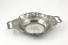 A `Tudric` pewter dish designed by Archibald Knox circa 1905, of hammered design with pierced rim