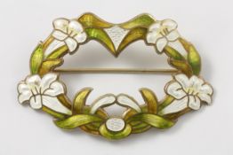 A silver gilt Art Nouveau enamel oval brooch circa 1905, with intertwined initials on the reverse