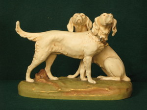 ROYAL DUX BOHEMIA CERAMIC FIGURE GROUP DEPICTING TWO HOUNDS (AT FAULT), NUMBERED TO BASE `1627`,